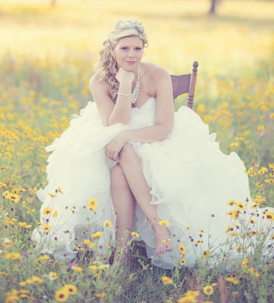 Photo by Moore Than Photography - No need for plush, tufted velvet, this relaxed bride takes her seat to a field of wild yellow daisies creating the perfect chic country portrait.