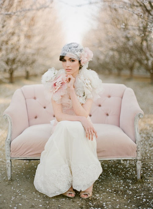 Photo by Stephanie Williams of This Modern Romance - An early 20th century loveseat, a coy pose, and a 1920s-inspired lace veil headdress has us dreaming of a wedding influenced by the Jazz Age, complete with flowing fringe accents and guests dancing the Charleston.