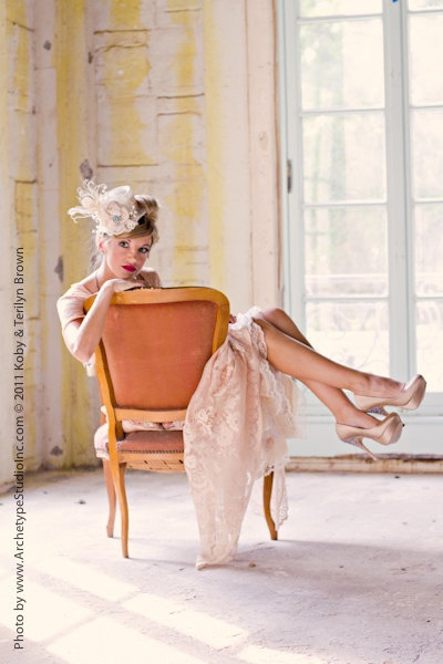 Photo by Archetype Studio Inc. - A fun and flirty alternative chair pose, this vintage bride takes advantage of a backwards-facing chair with a peekaboo pose, swinging her legs over the armrest, placing her chin on her hand and slyly making eyes past the photographer.